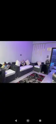 a living room with couches and pillows at Hamoo guest House hotel in Aswan