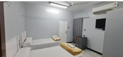 a white room with a couch and a tv at Hamoo guest House hotel in Aswan