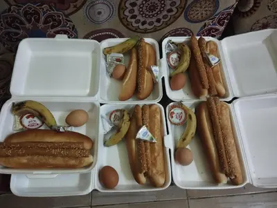 four styrofoam containers filled with hot dogs and eggs at Hamoo guest House hotel in Aswan