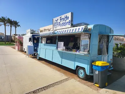 a blue food truck parked in front of a building at Mangroovy- 1br Imposing, Relaxing & Sea View in Hurghada