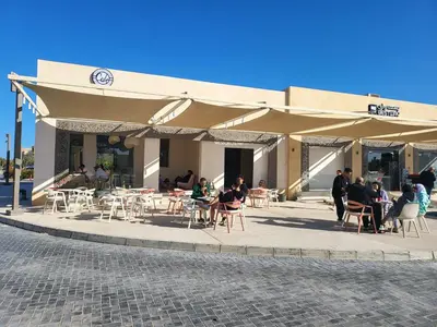 a group of people sitting outside of a building at Mangroovy- 1br Imposing, Relaxing & Sea View in Hurghada