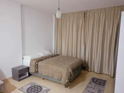 a bedroom with a bed and a large window at Avenue Alhambra in Hurghada