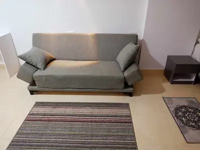 a couch in a living room with a rug at Avenue Alhambra in Hurghada