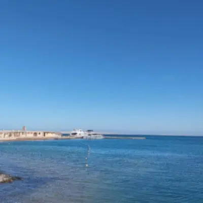 a large body of water with buildings in the background at Avenue Alhambra in Hurghada