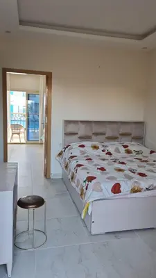 a bedroom with a large bed and a chair at Mirage Bay Resort & Aqua Park in Hurghada