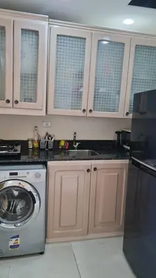 a kitchen with a sink and a washing machine at Mirage Bay Resort & Aqua Park in Hurghada