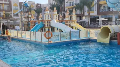 a water slide in a pool at a resort at Mirage Bay Resort & Aqua Park in Hurghada