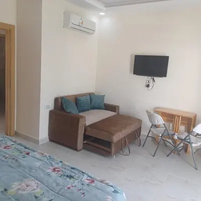 a living room with a couch and a tv at Mirage Bay Resort & Aqua Park in Hurghada