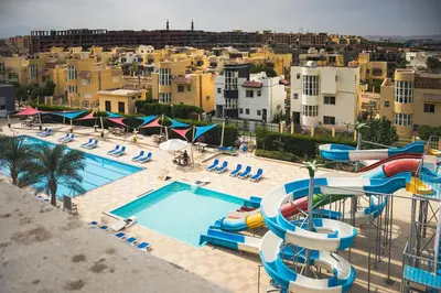 an aerial view of a pool with a water slide at Beachfront Boho Style apartment in Fanadir Bay in Hurghada