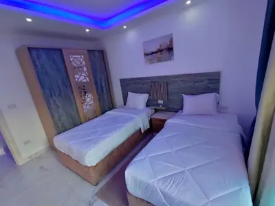 two beds in a room with purple lights at Fanadir Bay Compound in Hurghada