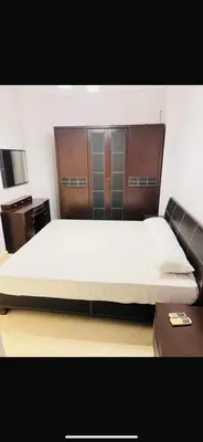 a bedroom with a large bed with a wooden headboard at Wintar guest house in Luxor