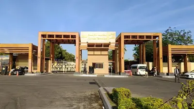 a large wooden structure with a parking lot at Wintar guest house in Luxor