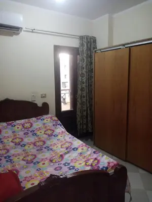 a bedroom with a bed and a door with a window at Wintar guest house in Luxor