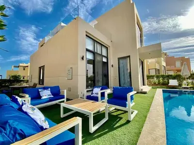 a backyard with blue furniture and a swimming pool at one bedroom in gouna in Hurghada