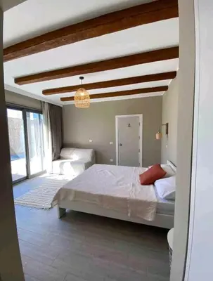 a bedroom with a large bed and a chandelier at one bedroom in gouna in Hurghada
