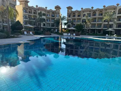 a large swimming pool in front of a building at Resort-Style Luxury Chalet with Pool and Sea View in Sahl Hasheesh in Hurghada