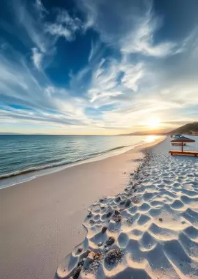 a bench on a beach with footprints in the sand at Resort-Style Luxury Chalet with Pool and Sea View in Sahl Hasheesh in Hurghada