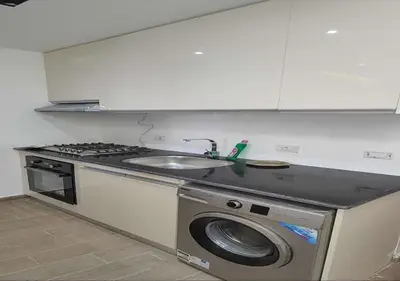 a kitchen with a washing machine and a sink at Resort-Style Luxury Chalet with Pool and Sea View in Sahl Hasheesh in Hurghada