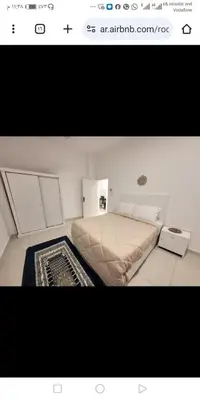 a small bedroom with a bed and a rug at Albairet in Al Karnak