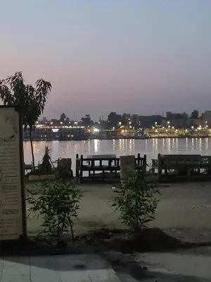a view of a body of water with two benches at Tut in Luxor