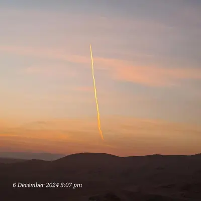 a jet trail in the sky at sunset at Tut in Luxor