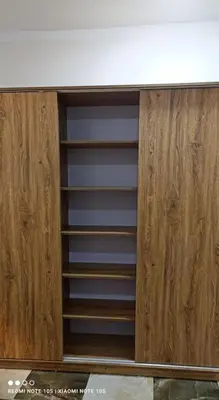 a wooden cabinet with empty shelves in a kitchen at Nový byt ve vyhledávané lokalitě in Hurghada