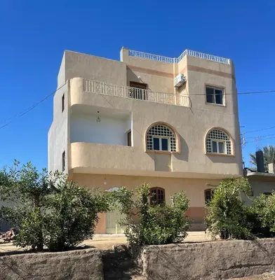 a building with trees in front of it at Flat in Kom in Luxor