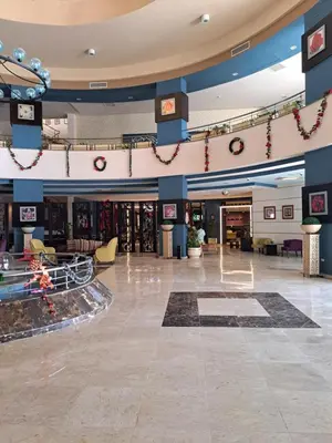 a large lobby with a mall with a lobby at Beach front 2BR at elkarma hotel & aqua park in Hurghada