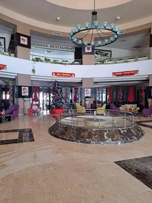 a shopping mall with a christmas tree in the middle at Beach front 2BR at elkarma hotel & aqua park in Hurghada