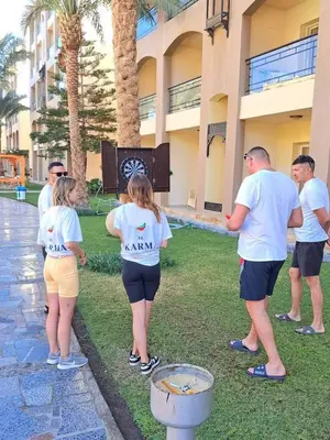 a group of people standing outside of a building at Beach front 2BR at elkarma hotel & aqua park in Hurghada