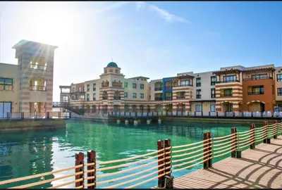 a view of a river with buildings and a fence at Marina Bliss-Seaside Retreat in Marsa Alam