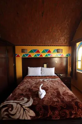 a bedroom with a bed with a white swan on it at Nubiano Cataract in Shellal