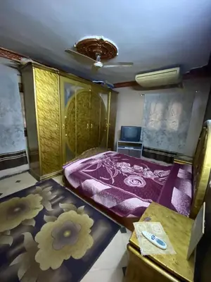 a small room with a bed and a table at Hotelمفروش in Aswan