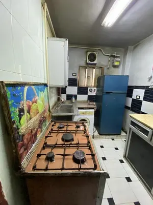 a kitchen with a stove top oven in a kitchen at Hotelمفروش in Aswan