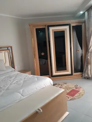 a bedroom with a bed and a large window at منتجع سكانديك in Hurghada