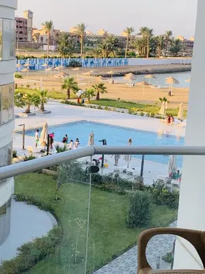 a view of a pool from a balcony of a resort at منتجع سكانديك in Hurghada