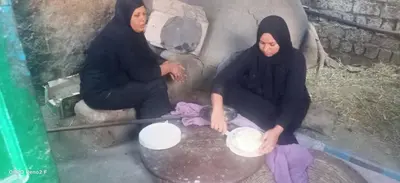 two women in black are cooking in a pan at Queen Sophie in Luxor