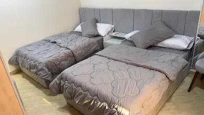 a bedroom with two beds and a couch at Serenity Cozy Studio Direct to the Pool In Hurghada in Hurghada