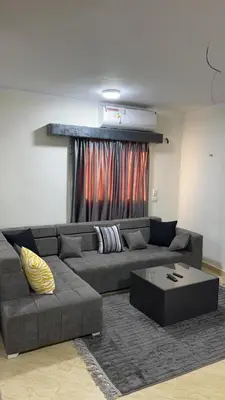 a living room with a couch and a coffee table at Serenity Cozy Studio Direct to the Pool In Hurghada in Hurghada