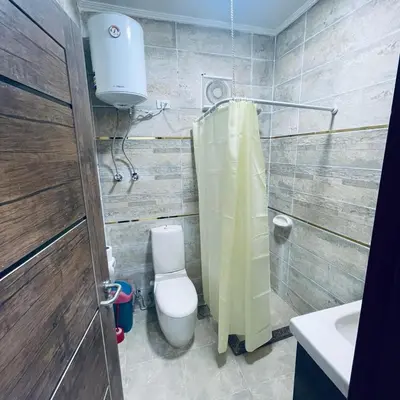 a bathroom with a toilet and a shower and a sink at 1 plus 1 in city centre Hurghada in Hurghada