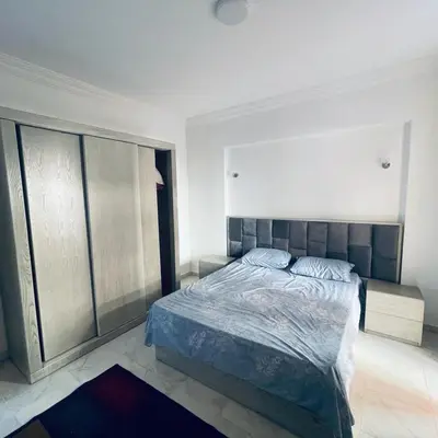 a bedroom with a bed and a large window at 1 plus 1 in city centre Hurghada in Hurghada