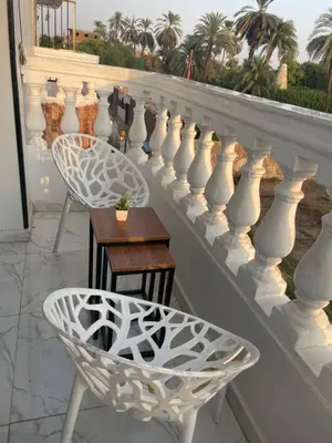 a white railing with a table and chairs on a balcony at Fantasy home in Al Aqālitah