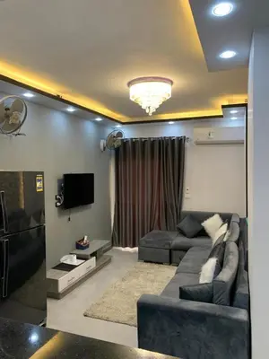 a living room with a couch and a tv at El Hadaba behind Raya in Hurghada