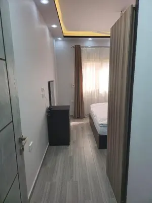 a bedroom with a bed and a dresser in a room at El Hadaba behind Raya in Hurghada