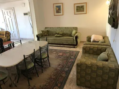a living room with a table and a couch at Apartment sea view in Hurghada