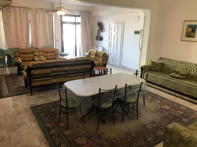 a living room with a table and chairs at Apartment sea view in Hurghada