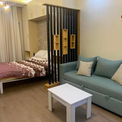 a living room with a couch and a bed at Luxury Sea View Studio at Alsaraya Resort Your Ultimate Sahl Hasheesh Getaway in Hurghada