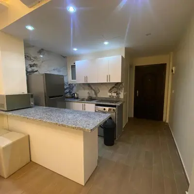 a kitchen with a counter top in a room at Luxury Sea View Studio at Alsaraya Resort Your Ultimate Sahl Hasheesh Getaway in Hurghada