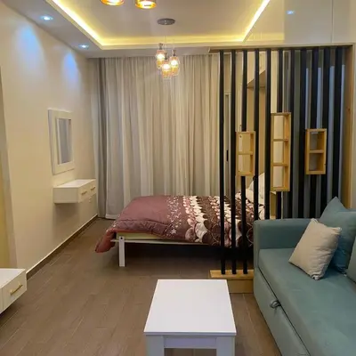 a living room with a bed and a couch at Luxury Sea View Studio at Alsaraya Resort Your Ultimate Sahl Hasheesh Getaway in Hurghada