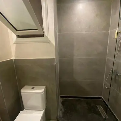 a small bathroom with a toilet and a shower at Luxury Sea View Studio at Alsaraya Resort Your Ultimate Sahl Hasheesh Getaway in Hurghada
